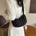 Quilted black cloud bag with puffy texture and integrated shoulder strap in a stylish view - Black