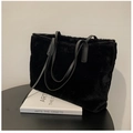 Detalle de bolso tote negro de felpa con asas de cuero y textura de piel sintética - Negro