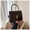 Detail view of a dark brown square bag with a vintage gold teardrop twist lock - Dark Brown