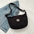 Minimalist black corduroy crescent crossbody bag featuring a cute cartoon bear patch - Black