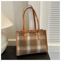 Bolso tote de tweed a cuadros marrones con asas de cuero y tachuelas doradas en mesa - Tostado