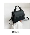 Minimalist black faux leather handbag with decorative knot handle and gold hardware - Black