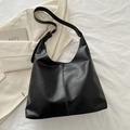 Minimalist black matte leather hobo shoulder bag with adjustable strap and seam detail - Black