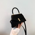 Minimalist black geometric crossbody bag with top handle and gold hardware detail - Black