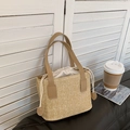 Beige woven straw handbag with brown leather handles and a secure drawstring liner - Khaki