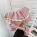 Pink pleated dumpling bag featuring a large pearl handle and ruffled shoulder strap - Pink