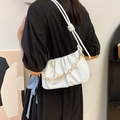 White pleated cloud shoulder bag with pearl and gold floral chain strap on a model - Beige