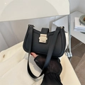 Minimalist black matte PU leather underarm bag with gold metal buckle on a chair - Black
