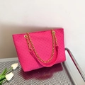 Fuchsia woven tote bag with elegant gold chain strap and textured faux leather finish - Rose Red