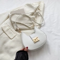 Minimalist white crescent shoulder bag with gold clasp shown on a cream blazer - White
