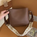 Dark brown leather box bag featuring a wide retro geometric woven shoulder strap - Brown