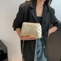 Quilted gold shoulder bag with chain strap and metallic finish for elegant commuters - Gold