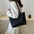 Large black quilted tote bag with diamond pattern and leather base worn over the shoulder - Black