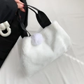 White faux fur handbag with black strap and decorative puff ball on white fabric - White