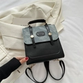 Eleganter Rucksack aus schwarzem Leder und blauem Denim mit goldener Hardware - Schwarz