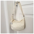 Detail of cream waffle canvas crossbody bag with adjustable strap and cute puppy pendant - White With Plush Pendant