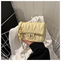 Detail of beige quilted shoulder bag with V-shaped stitching and golden chain with pearl - Yellow