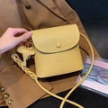 Yellow litchi pattern leather crossbody bag with elephant charm and woven strap - Light Yellow