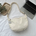 Minimalist off-white waffle canvas crossbody bag with wave edge and cute charm detail - White