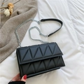 Black quilted crossbody bag with geometric triangle patterns and silver chain strap - Black