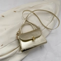 Mini golden textured metallic handbag with fine shoulder strap and rectangular clasp - Gold