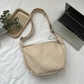 Beige corduroy crescent crossbody bag with cute lamb charm on white fabric background - Corduroy/Canvas Style (With Pendant) / Khaki