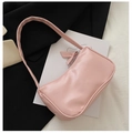Pink PU leather baguette shoulder bag with ribbon bow detail on minimal background - Pink