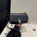 Chic black leather underarm bag with silver C-buckle and elegant knotted shoulder strap - Black