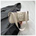 Macro shot of off-white rectangle underarm bag with large silver square buckle detail - White