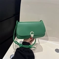 Emerald green crossbody bag with gold C-buckle and knotted shoulder strap detail - Green