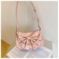 Pink bow-shaped shoulder bag with pearl chain detail on a minimalist white background - Pink