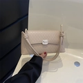 Chic beige quilted baguette handbag with silver lock and decorative knot shoulder strap - Khaki