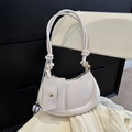 White half-moon crossbody bag with mini pouch charm and knotted shoulder strap detail - White