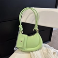 Light green crescent underarm bag with mini pouch and rope strap on white chair - Green