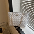 White quilted tote bag with gold chain straps and rectangular metallic buckle detail - White
