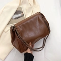 Brown soft leather tote bag with chain strap and fashion logo on white fabric - Brown