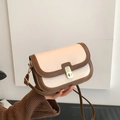 Borsa a tracolla retrò crema e marrone con fibbia in metallo dorato su modella - Bianco