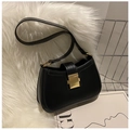 Primer plano de bolso de hombro negro mate con hebilla de metal dorado sobre felpa blanca - Negro