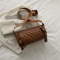 Brown quilted cylindrical crossbody bag with wide shoulder strap and metal zipper detail - Brown
