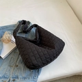 Chic black quilted puffer shoulder bag with a wide strap for casual summer styling - Black