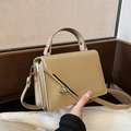 Structured khaki faux leather crossbody bag with a distinctive golden metal bar twist lock - Khaki