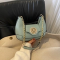 Mint green half-moon shoulder bag featuring a unique gold circular buckle and chain strap - Green
