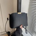 Matte black leather bucket bag with gold metal buckle and adjustable shoulder strap - Black