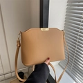 Minimalist tan leather bucket bag with gold metal hardware and adjustable shoulder strap - Khaki