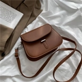 Classic brown saddle bag in smooth faux leather with silver metal bar detail on flap - Brown