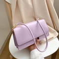 Minimalist purple faux leather rectangular baguette bag on a chair for women - Purple