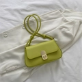 Detail of lime green leather crossbody bag with vertical metal push-lock and knotted strap - Green