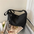 Minimalist black nylon hobo bag with adjustable strap and checkered doll charm accessory - With Checkerboard Charm / Black