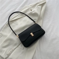Minimalist black leather saddle bag for women with golden buckle and sleek shoulder strap - Black