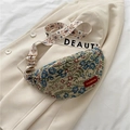 Floral jacquard crescent sling bag in blue and red with wide patterned shoulder strap - Blue